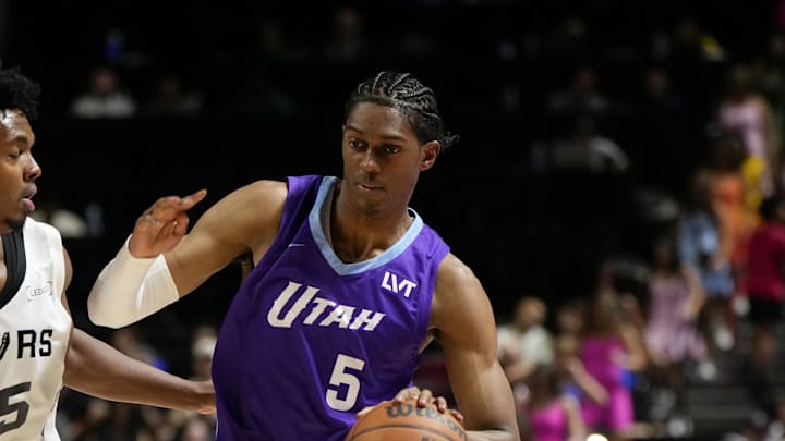 Jul 14, 2025; Las Vegas, NV, USA;  Utah Jazz forward Cody Williams (5) drives the ball against San Antonio Spurs guard Harrison Ingram (55) during the first half of a NBA basketball game at the Thomas & Mack Center. Mandatory Credit: Lucas Peltier-Imagn Images