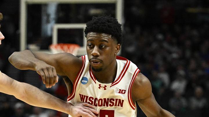 Mar 19, 2026; Portland, OR, USA; Wisconsin Badgers guard John Blackwell (25) drives against High Point Panthers guard Conrad Martinez (9) during the second half of a first round game of the men's 2026 NCAA Tournament at Moda Center. Mandatory Credit: Troy Wayrynen-Imagn Images