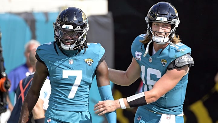 Oct 27, 2024; Jacksonville, Florida, USA; Jacksonville Jaguars quarterback Trevor Lawrence (16) celebrates a touchdown with wide receiver Brian Thomas Jr. (7) during the second half against the Green Bay Packers at EverBank Stadium. Mandatory Credit: Melina Myers-Imagn Images