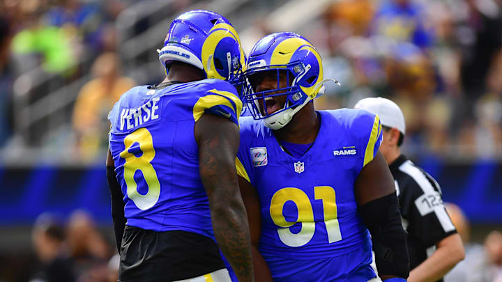 Oct 6, 2024; Inglewood, California, USA; Los Angeles Rams linebacker Jared Verse (8) and defensive tackle Kobie Turner (91) celebrate after sacking Green Bay Packers quarterback Jordan Love (10) during the first half at SoFi Stadium. Mandatory Credit: Gary A. Vasquez-Imagn Images