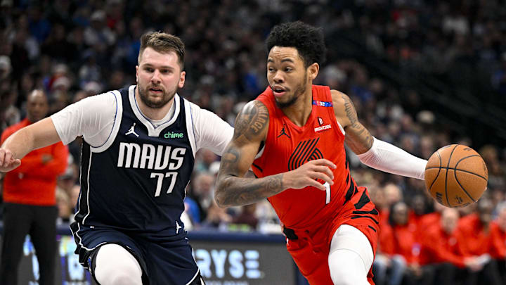 Dec 23, 2024; Dallas, Texas, USA; Portland Trail Blazers guard Anfernee Simons (1) drives to the basket past Dallas Mavericks guard Luka Doncic (77) during the second quarter at the American Airlines Center. Mandatory Credit: Jerome Miron-Imagn Images