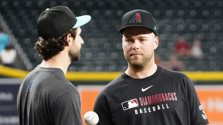 Arizona Diamondbacks pitchers Zac Gallen and Corbin Burnes talk before playing the San Francisco Giants at Chase Field on Sept. 17, 2025.