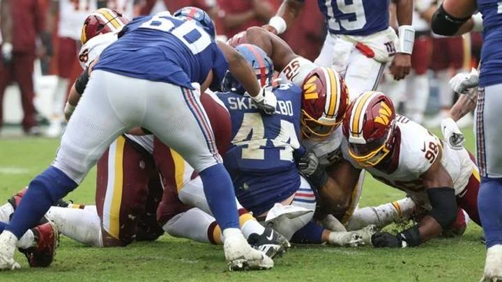 Oct 11, 2026; Landover, Maryland, USA; New York Giants running back Cam Skattebo (44) fumbles the ball during overtime against the Washington Commanders at Northwest Stadium.