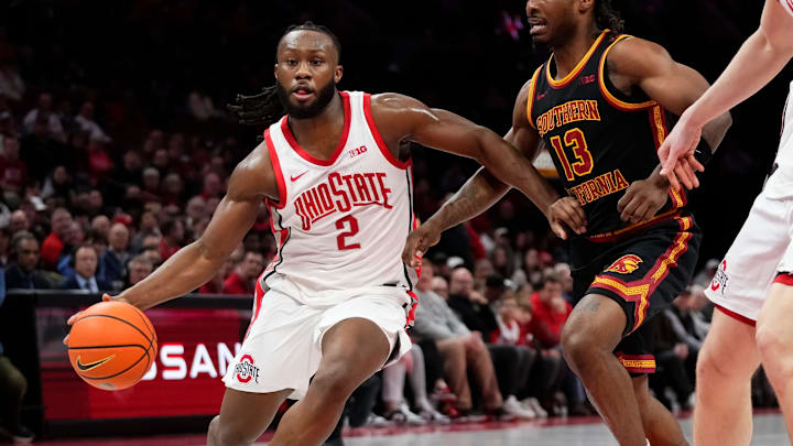 Ohio State Buckeyes guard Bruce Thornton (2) drives past USC Trojans guard Kam Woods (13) during the first half of the NCAA men's basketball game at the Schottenstein Center on Feb. 11, 2026.