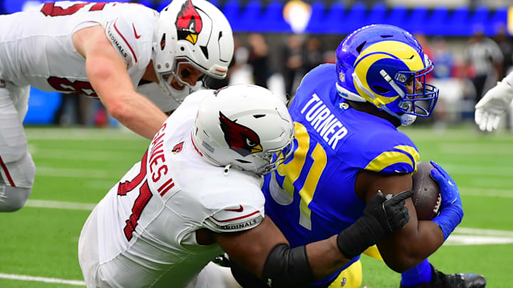 Jan 4, 2026; Inglewood, California, USA; Los Angeles Rams defensive end Kobie Turner (91) is tackled by Arizona Cardinals guard Jon Gaines II (71) after recovering a fumble during the first half at SoFi Stadium. Mandatory Credit: Gary A. Vasquez-Imagn Images Jan 4, 2026; Inglewood, California, USA; Los Angeles Rams defensive end Kobie Turner (91) is tackled by Arizona Cardinals guard Jon Gaines II (71) after recovering a fumble during the first half at SoFi Stadium. Mandatory Credit: Gary A. Vasquez-Imagn Images