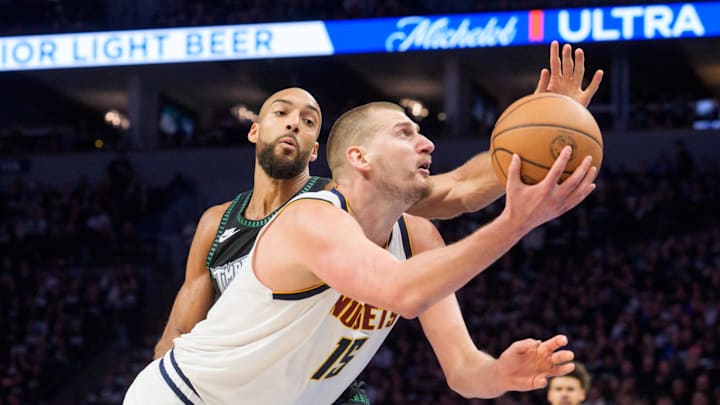 Apr 25, 2026; Minneapolis, Minnesota, USA; Denver Nuggets center Nikola Jokic (15) shoots defended by Minnesota Timberwolves center Rudy Gobert (27) in the third quarter at Target Center. Mandatory Credit: Matt Blewett-Imagn Images