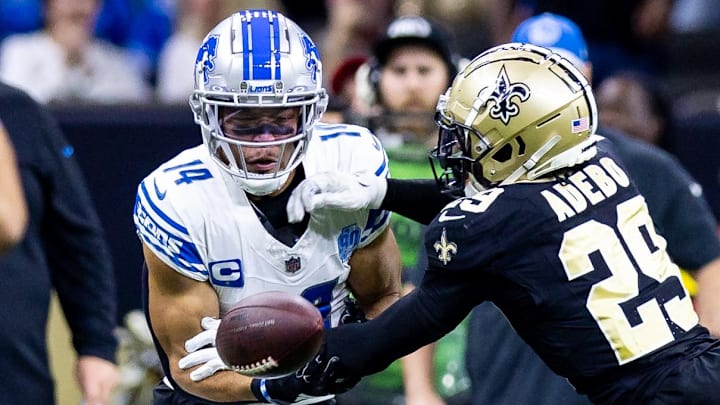New Orleans Saints cornerback Paulson Adebo (29) blocks the pass attempt to Detroit Lions wide receiver Amon-Ra St. Brown.