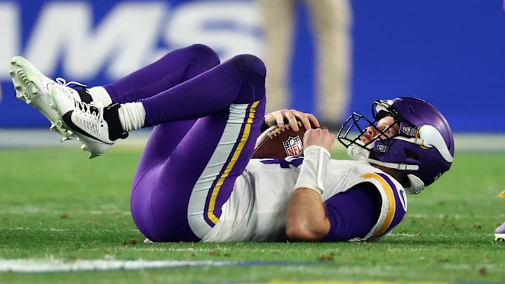 Jan 13, 2025; Glendale, AZ, USA; Minnesota Vikings quarterback Sam Darnold (14) is sacked against the Los Angeles Rams during the first half in an NFC wild card game at State Farm Stadium. Jan 13, 2025; Glendale, AZ, USA; Minnesota Vikings quarterback Sam Darnold (14) is sacked against the Los Angeles Rams during the first half in an NFC wild card game at State Farm Stadium.
