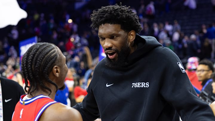 Jan 24, 2025; Philadelphia, Pennsylvania, USA; Philadelphia 76ers guard Tyrese Maxey (L) reacts with injured Joel Embiid (R) after a victory against the Cleveland Cavaliers at Wells Fargo Center. Mandatory Credit: Bill Streicher-Imagn Images