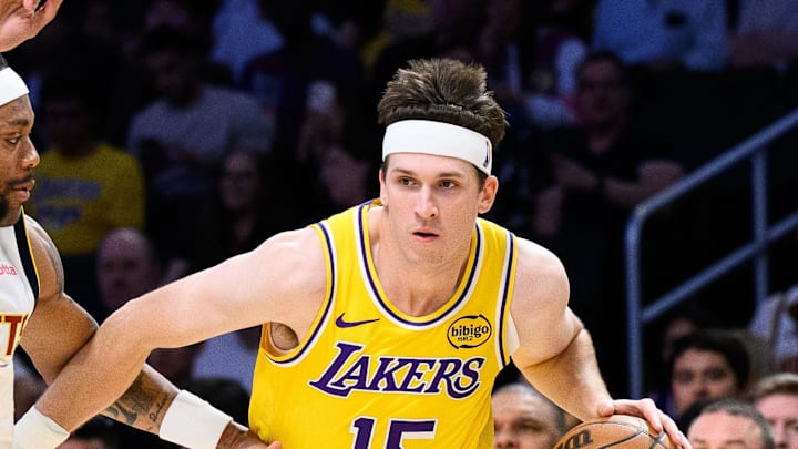Mar 14, 2026; Los Angeles, California, USA; Los Angeles Lakers guard Austin Reaves (15) drives the ball while under pressure from Denver Nuggets guard Bruce Brown (11) during the first half at Crypto.com Arena.