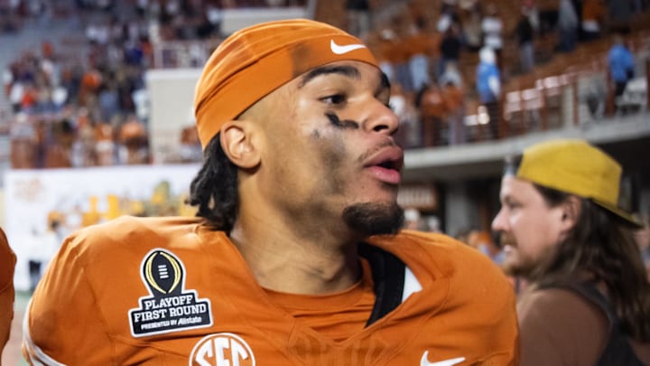 Dec 21, 2024; Austin, Texas, USA; Texas Longhorns offensive lineman Malik Agbo (80) celebrates with wide receiver DeAndre Moore Jr. (0) after defeating the Clemson Tigers during the CFP National playoff first round at Darrell K Royal-Texas Memorial Stadium. Mandatory Credit: Mark J. Rebilas-Imagn Images