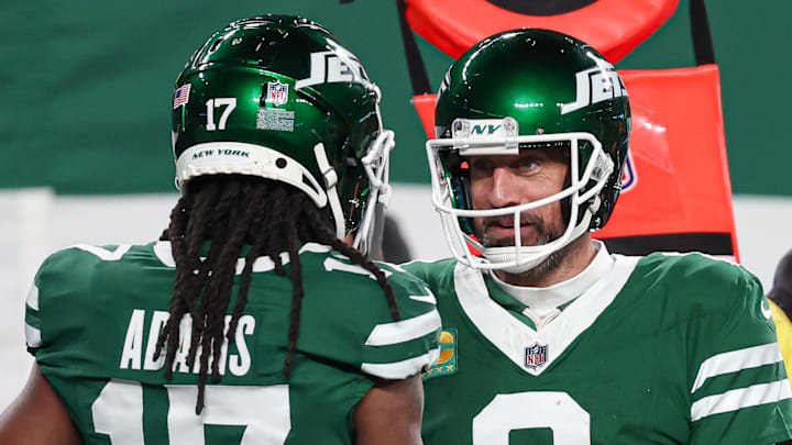 Jan 5, 2025; East Rutherford, New Jersey, USA; New York Jets quarterback Aaron Rodgers (8) and wide receiver Davante Adams (17) celebrates after a touchdown during the second half against the Miami Dolphins at MetLife Stadium. Mandatory Credit: Vincent Carchietta-Imagn Images