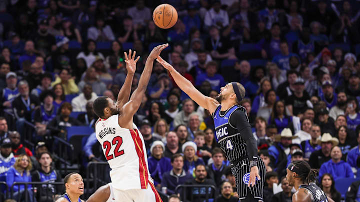 Dec 9, 2025; Orlando, Florida, USA; Miami Heat forward Andrew Wiggins (22) shoots against Orlando Magic guard Jalen Suggs (4) during the second half at Kia Center. Mandatory Credit: Mike Watters-Imagn Images