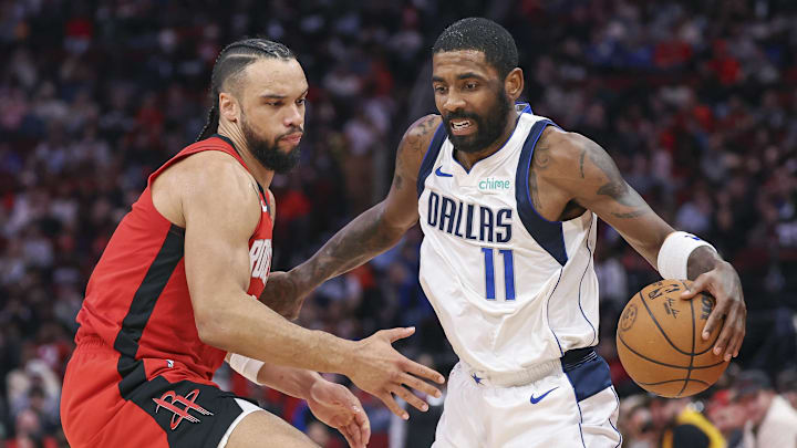 Jan 1, 2025; Houston, Texas, USA; Dallas Mavericks guard Kyrie Irving (11) controls the ball as Houston Rockets forward Dillon Brooks (9) defends during the third quarter at Toyota Center. Mandatory Credit: Troy Taormina-Imagn Images