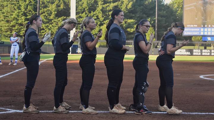 The South Warren seniors line up pre-game at the opening round of the KHSAA State Softball Tournament Thursday, June 4, 2026. The Lady Spartan graduates have led the team through their undefeated season. The South Warren seniors line up pre-game at the opening round of the KHSAA State Softball Tournament Thursday, June 4, 2026. The Lady Spartan graduates have led the team through their undefeated season.