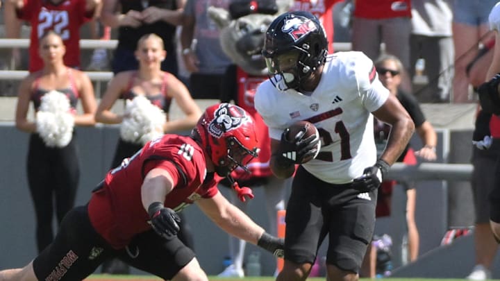Sep 28, 2024; Raleigh, North Carolina, USA; Northern Illinois cornerback Dev'ion Reynolds (21) runs the ball against North Carolina State Wolfpack linebacker Caden Fordham (10) at Carter-Finley Stadium. Mandatory Credit: Zachary Taft-Imagn Images Sep 28, 2024; Raleigh, North Carolina, USA; Northern Illinois cornerback Dev'ion Reynolds (21) runs the ball against North Carolina State Wolfpack linebacker Caden Fordham (10) at Carter-Finley Stadium. Mandatory Credit: Zachary Taft-Imagn Images