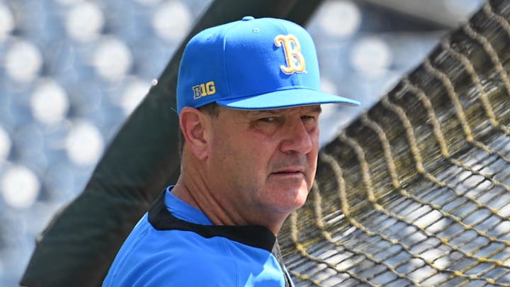 Jun 14, 2025; Omaha, Neb, USA;  UCLA Bruins head coach John Savage watches the team warm up before the game against the Murray State Races at Charles Schwab Field. Mandatory Credit: Steven Branscombe-Imagn Images