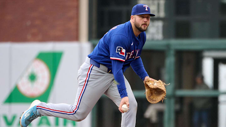 Apr 27, 2025; San Francisco, California, USA; Texas Rangers first baseman Jake Burger (21) looks to toss the ball to a teammate against the San Francisco Giants during the seventh inning at Oracle Park.