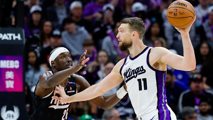 Mar 27, 2025; Sacramento, California, USA; Sacramento Kings forward Domantas Sabonis (11) controls the ball against Portland Trail Blazers center Duop Reath (26) during the third quarter at Golden 1 Center.