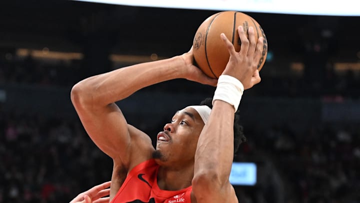 Toronto Raptors forward Scottie Barnes tries to get a shot off against Sacramento Kings center Maxime Reynaud.
