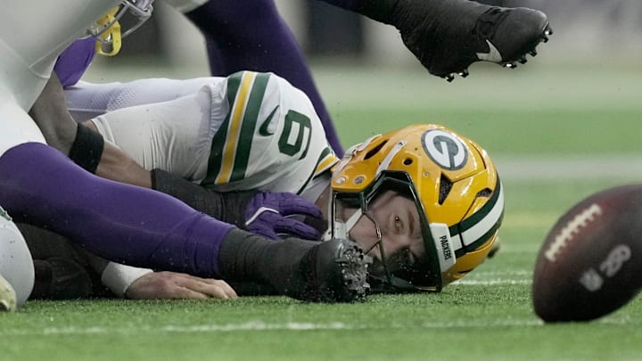 Green Bay Packers quarterback Clayton Tune (6) watches his fumble after being sacked by the Vikings.