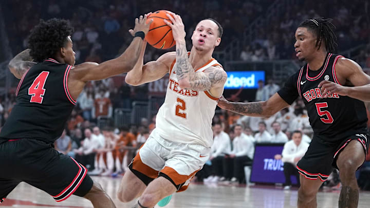 Texas Longhorns guard Chendall Weaver (2) drives to the basket against Georgia Bulldogs guard Marcus Millender (4) and guard Jeremiah Wilkinson (5) during the first half at Moody Center. 