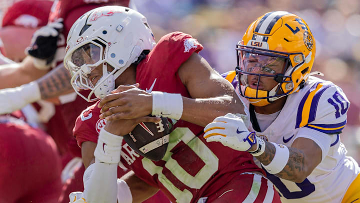 LSU Tigers safety Dashawn Spears (10) sacks Arkansas Razorbacks quarterback Taylen Green (10) during the first half at Tiger Stadium. 