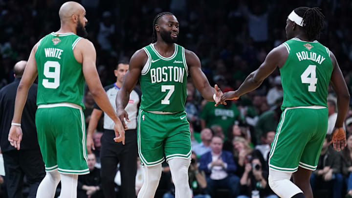  Boston Celtics guard Jaylen Brown (7), guard Jrue Holiday (4), and guard Derrick White (9) react after a play against the New York Knicks in the second half at TD Garden.