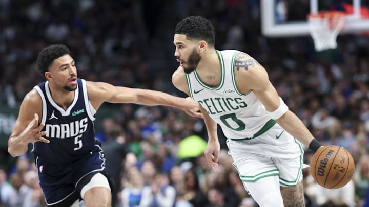 Jan 25, 2025; Dallas, Texas, USA;  Boston Celtics forward Jayson Tatum (0) controls the ball as Dallas Mavericks guard Quentin Grimes (5) defends during the second half at American Airlines Center. Mandatory Credit: Kevin Jairaj-Imagn Images