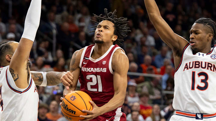 Arkansas Razorbacks guard D.J. Wagner (21) goes up for a layup over Auburn Tigers forward Johni Broome (4) as Auburn Tigers take on Arkansas Razorbacks at Neville Arena in Auburn, Ala., on Wednesday, Feb. 19, 2025.