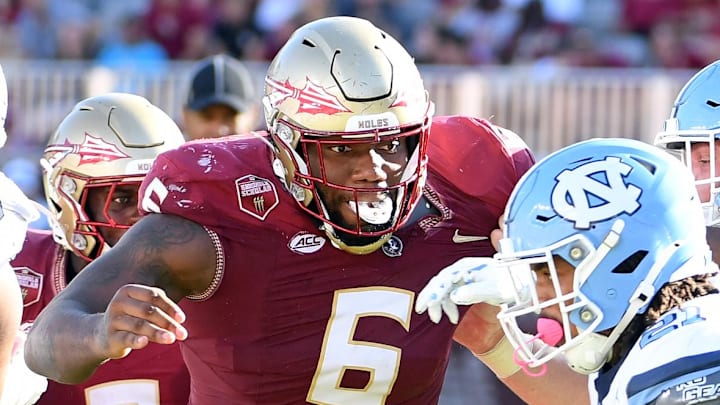 Nov 2, 2024; Tallahassee, Florida, USA;  Florida State Seminoles defensive tackle Darrell Jackson Jr (6) pursues North Carolina Tarheels running back Davion Gause (21) in the second quarter at Doak S. Campbell Stadium. Mandatory Credit: Robert Myers-Imagn Images