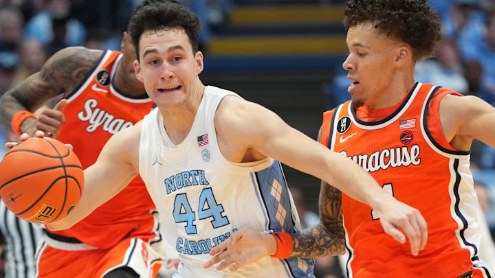 Feb 2, 2026; Chapel Hill, North Carolina, USA; North Carolina Tar Heels guard Luka Bogavac (44) with the ball as Syracuse Orange guard Nate Kingz (4) defends in the second half at Dean E. Smith Center. Mandatory Credit: Bob Donnan-Imagn Images