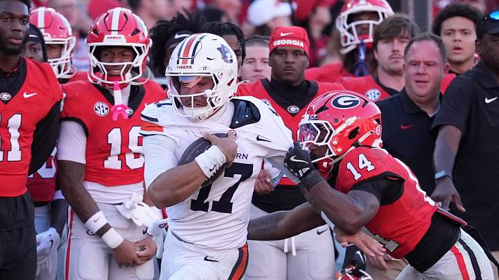 Auburn quarterback Byrum Brown runs for a gain past Georgia safety Rasean Dinkins (14) during the third quarter at Sanford Stadium Auburn quarterback Byrum Brown runs for a gain past Georgia safety Rasean Dinkins (14) during the third quarter at Sanford Stadium