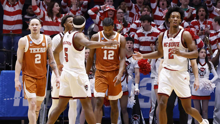 Mar 17, 2026; Dayton, OH, USA; NC State Wolfpack guard Tre Holloman (5) celebrates a play with NC State Wolfpack guard Jr. Paul McNeil (2) in the second half against the Texas Longhorns during a first four game of the men's 2026 NCAA Tournament at University of Dayton Arena. Mandatory Credit: Rick Osentoski-Imagn Images