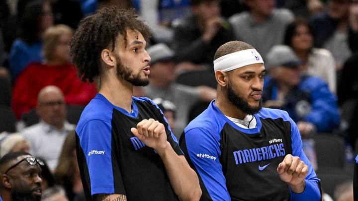 Dec 23, 2024; Dallas, Texas, USA; Dallas Mavericks center Dereck Lively II (left) and center Daniel Gafford (center) and guard Quentin Grimes (right) celebrate on the team bench during the second half against the Portland Trail Blazers at the American Airlines Center. Mandatory Credit: Jerome Miron-Imagn Images