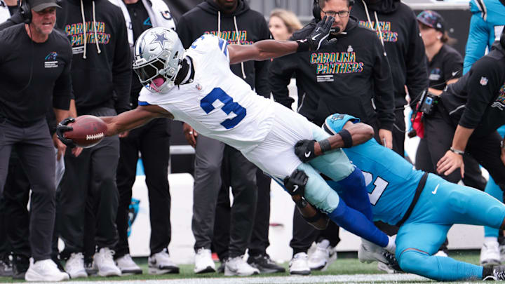 Dallas Cowboys wide receiver George Pickens reaches while Carolina Panthers cornerback Mike Jackson tackles. Dallas Cowboys wide receiver George Pickens reaches while Carolina Panthers cornerback Mike Jackson tackles.