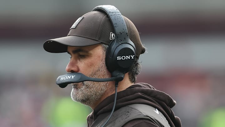 Dec 28, 2025; Cleveland, Ohio, USA; Cleveland Browns head coach Kevin Stefanski speaks with quarterback Shedeur Sanders (12) during a time out in the second quarter against the Pittsburgh Steelers at Huntington Bank Field. Mandatory Credit: Scott Galvin-Imagn Images