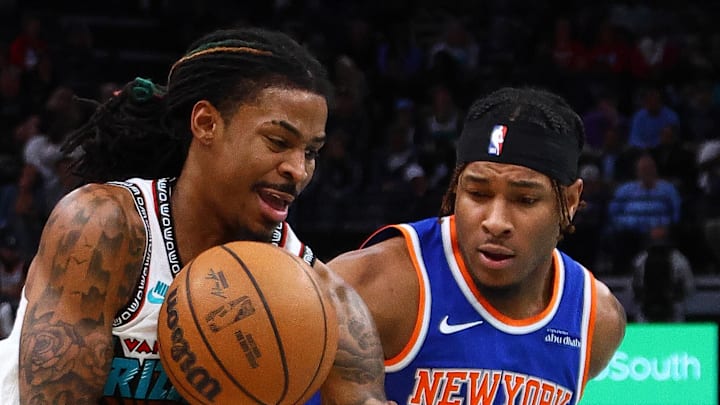 Memphis Grizzlies guard Ja Morant drives to the basket between New York Knicks guard Miles McBride.