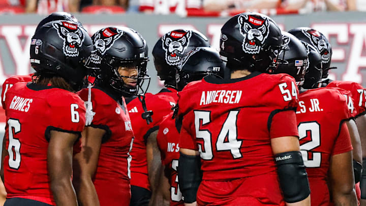 Sep 27, 2025; Raleigh, North Carolina, USA;  North Carolina State Wolfpack huddle during the first half of the game against Virginia Tech Hokies at Carter-Finley Stadium. Mandatory Credit: Jaylynn Nash-Imagn Images