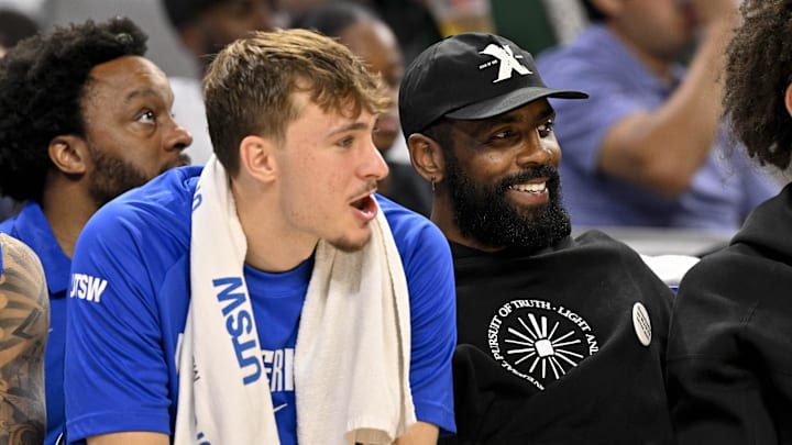 Oct 6, 2025; Fort Worth, Texas, USA; Dallas Mavericks forward Cooper Flagg (left) and guard Kyrie Irving (right) watch the game against the Oklahoma City Thunder during the second half at Dickie's Arena. Mandatory Credit: Jerome Miron-Imagn Images
