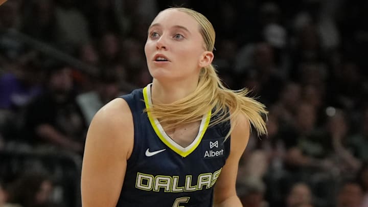 Jul 7, 2025; Phoenix, Arizona, USA; Dallas Wings guard Paige Bueckers (5) drives on the Phoenix Mercury in the first half at Footprint Center. Mandatory Credit: Rick Scuteri-Imagn Images