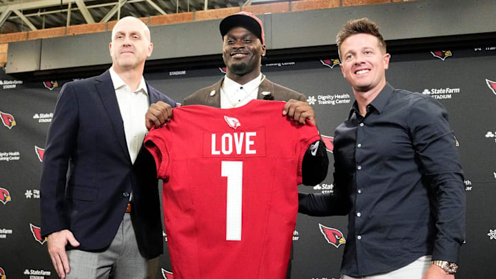 Arizona Cardinals general manager Monti Ossenfort and head coach Mike LaFleur (right) introduce their first-round draft pick running back Jeremiyah Love during a news conference at the Cardinals Dignity Health training facility on April 24, 2026, in Tempe, Ariz.