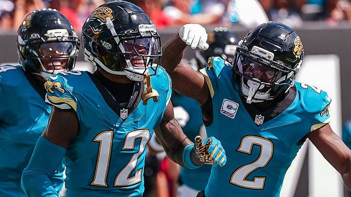 Jacksonville Jaguars wide receiver Travis Hunter (12) celebrates his first NFL interception with Jacksonville Jaguars cornerback Jourdan Lewis (2) in the second quarter during an NFL football game at EverBank Stadium, Sunday, September 27, 2026, in Jacksonville, Fla. [Doug Engle/Florida Times-Union]
