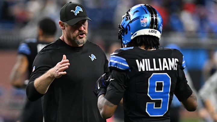 Detroit Lions head coach Dan Campbell greets wide receiver Jameson Williams (9)