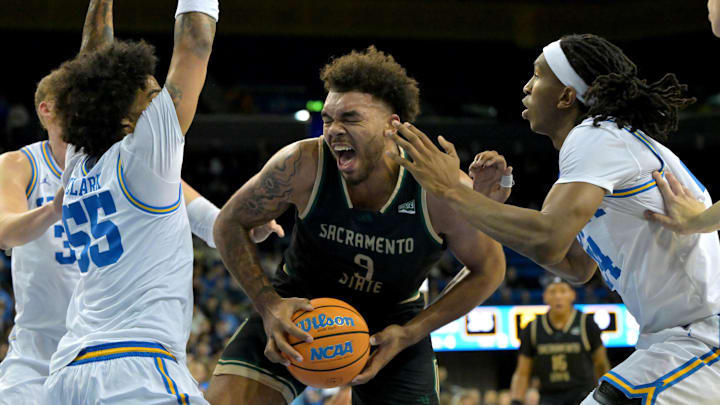 Nov 18, 2025; Los Angeles, California, USA; Sacramento State Hornets forward Jeremiah Cherry (9) is defended by UCLA Bruins guard Skyy Clark (55) and center Steven Jamerson II (24). Nov 18, 2025; Los Angeles, California, USA; Sacramento State Hornets forward Jeremiah Cherry (9) is defended by UCLA Bruins guard Skyy Clark (55) and center Steven Jamerson II (24).