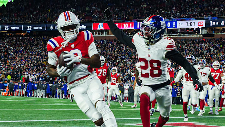 Dec 1, 2025; Foxborough, Massachusetts, USA; New England Patriots wide receiver Kayshon Boutte (9) catches a pass for a touchdown against New York Giants cornerback Cor'Dale Flott (28) during the first quarter at Gillette Stadium. Mandatory Credit: David Butler II-Imagn Images
