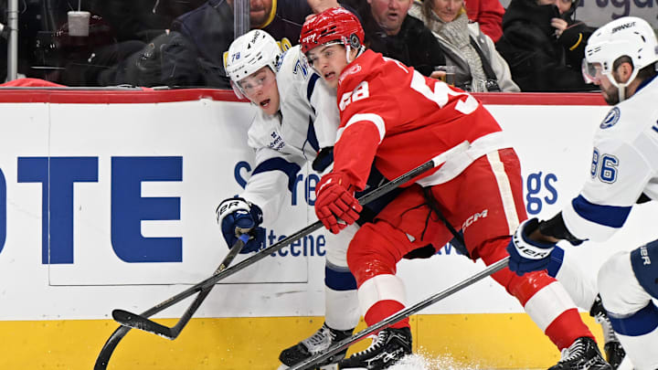 Nov 28, 2025; Detroit, Michigan, USA; Tampa Bay Lightning defenseman Emil Lilleberg (78) passes the puck past Detroit Red Wings Emmitt Finnie (58) in the third period at Little Caesars Arena. Mandatory Credit: Lon Horwedel-Imagn Images Nov 28, 2025; Detroit, Michigan, USA; Tampa Bay Lightning defenseman Emil Lilleberg (78) passes the puck past Detroit Red Wings Emmitt Finnie (58) in the third period at Little Caesars Arena. Mandatory Credit: Lon Horwedel-Imagn Images