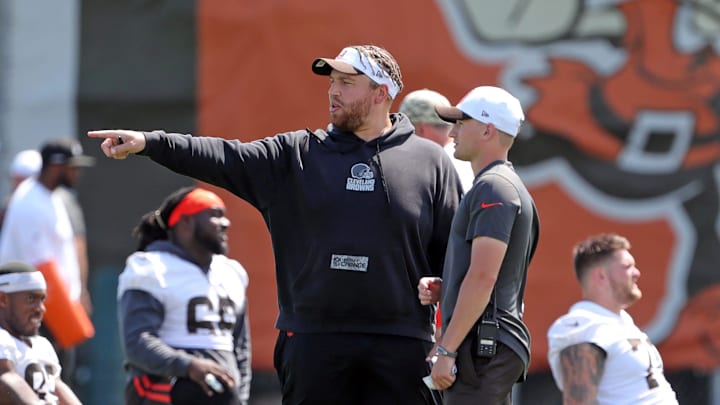 Browns offensive line coach Andy Dickerson, left, watches players warm up during minicamp, Thursday, June 13, 2024, in Berea.