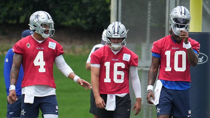 Dallas Cowboys quarterbacks Dak Prescott, Sam Howell, and Joe Milton III walk onto the field during minicamp practice Dallas Cowboys quarterbacks Dak Prescott, Sam Howell, and Joe Milton III walk onto the field during minicamp practice