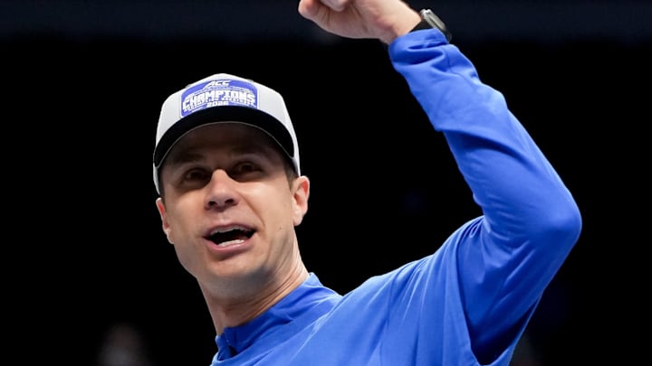 Mar 14, 2026; Charlotte, NC, USA; Duke Blue Devils head coach Jon Scheyer cuts down the net after defeating the Virginia Cavaliers in the men's ACC Conference Tournament Championship at Spectrum Center. Mandatory Credit: Bob Donnan-Imagn Images Mar 14, 2026; Charlotte, NC, USA; Duke Blue Devils head coach Jon Scheyer cuts down the net after defeating the Virginia Cavaliers in the men's ACC Conference Tournament Championship at Spectrum Center. Mandatory Credit: Bob Donnan-Imagn Images